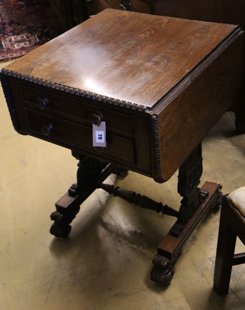 A William IV rosewood drop-flap sewing table, fitted two frieze drawers, carved with acanthus to end supports and feet, width 53cm dept